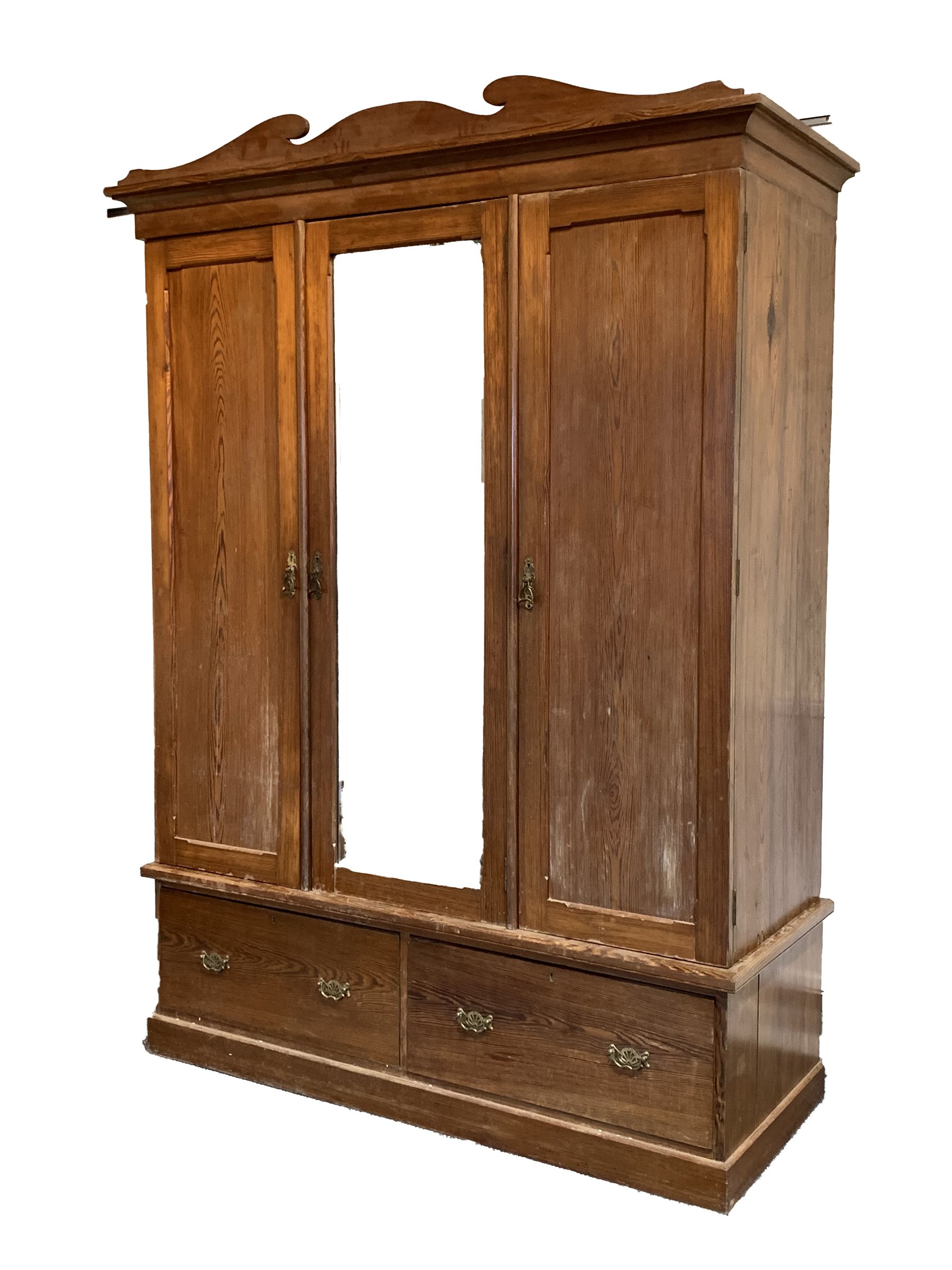 Edwardian pitch pine triple wardrobe, shaped arched pediment over bevelled mirror glazed door enclos