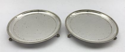 Pair of silver waiters with bead edge decoration on claw and ball feet D15cm London 1974 Maker A Chi
