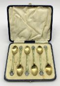 Set of six silver gilt coffee spoons, the finials decorated with a coloured enamel flower head, the