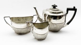 Late Victorian silver three piece tea set of oval design with half body reeded decoration, the tea p