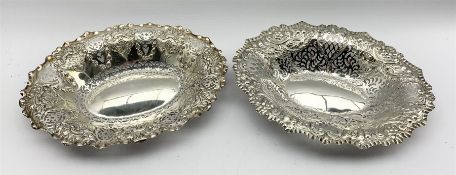 Victorian silver oval basket with pierced and embossed decoration and another of similar design each