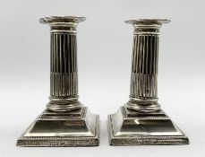 Pair of Edwardian silver table candlesticks with reeded columns on stepped square bases H13cm Sheffi