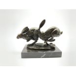 Bronze figure group, modelled as two hares in chase, signed Nick and with foundry mark, raised upon