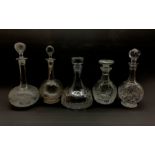 Five glass decanters comprising a heavy slice cut ships decanter, unmarked, Stuart mallet form decan