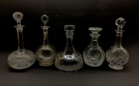 Five glass decanters comprising a heavy slice cut ships decanter, unmarked, Stuart mallet form decan