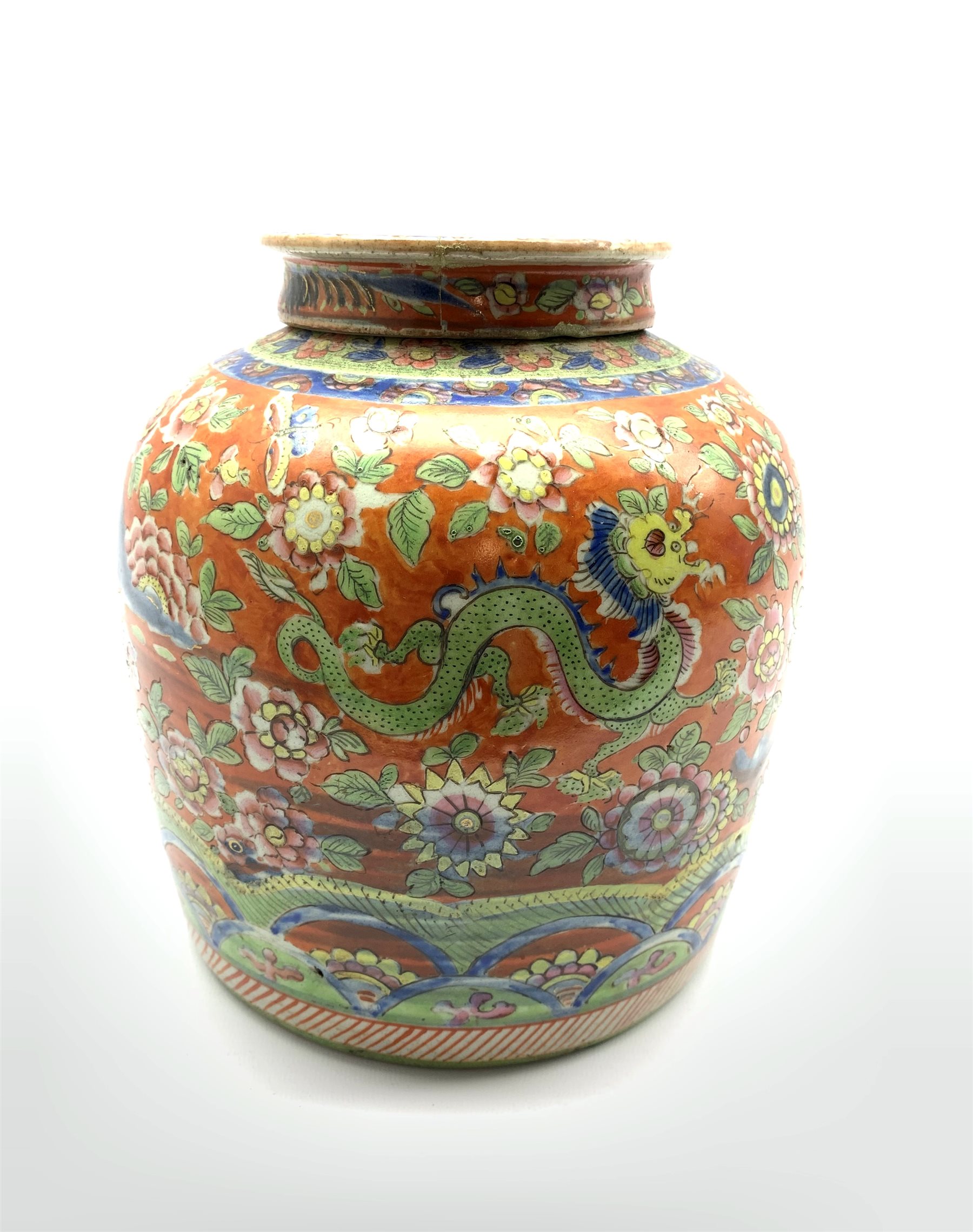 Chinese red ground ginger jar and cover, decorated in underglaze blue with a mountanious landscape a