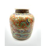 Chinese red ground ginger jar and cover, decorated in underglaze blue with a mountanious landscape a