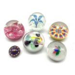 Six glass paperweights including two by Strathearn, Caithness, another having latticinio and leaf de
