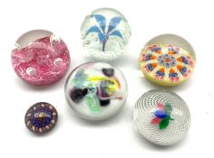 Six glass paperweights including two by Strathearn, Caithness, another having latticinio and leaf de