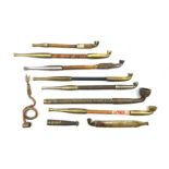 A collection of Japanese Kiseru smoking pipes, to include bamboo and brass long stemmed examples and