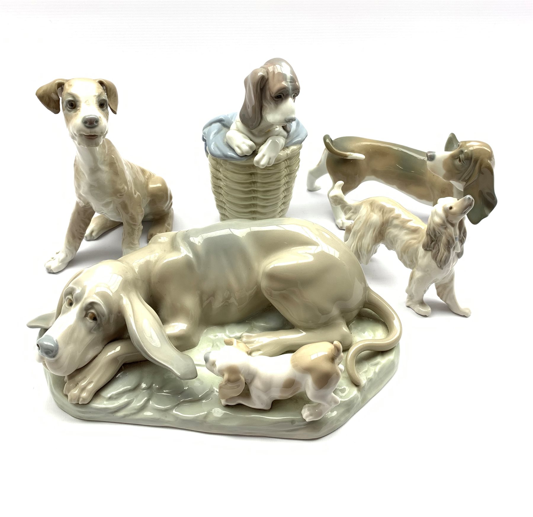 Lladro Afghan hound H12cm, Lladro Bassett hound, two other Lladro dogs and a large Nao group of a ho