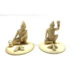 Pair of late 19th/early20th Century Indian carved ivory seated figures of street hawkers on circula