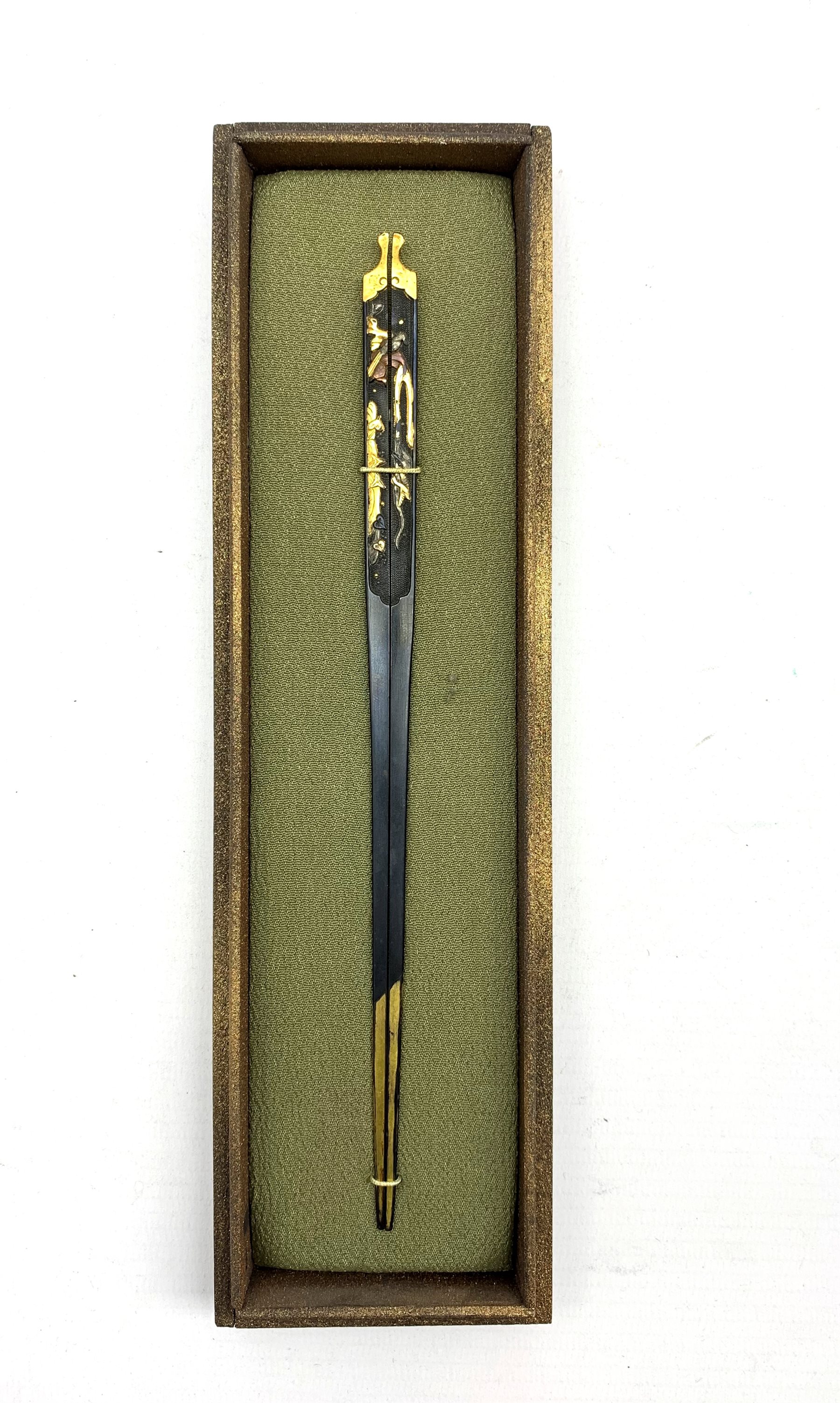 19th century Japanese wari-kogai decorated with gold and shakudo decoration, L21cm in display case