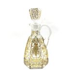 Early 20th century French glass claret jug of hexagonal design incised and gilded with trailing foli