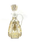 Early 20th century French glass claret jug of hexagonal design incised and gilded with trailing foli