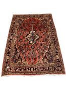 Persian Sarouk full pile red ground Persian Sarouk carpet, with floral medallion 305cm x 200cm