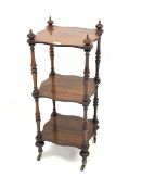 Small Victorian rosewood three tier whatnot, with turned finials, serpentine shelves, raised on turn