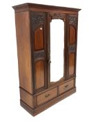 Late Victorian mahogany wardrobe, projecting cornice over panelled and carved front, centre bevelled