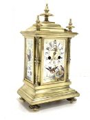 20th century brass mantel clock, three finials over caddy top and three panels painted with birds an