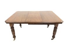 Edwardian mahogany wind out extending dining table, the top with canted corners over turned supports
