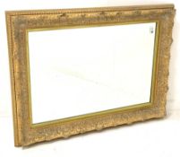 20th century wall mirror in floral moulded gilt frame