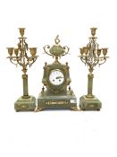 Late 19th century onyx and gilt three-piece clock garniture, the clock case surmounted by an urn sha