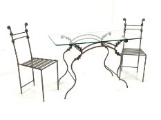 Blacksmith made wrought metal garden suite, comprising a table with glass top raised on spiralled, s