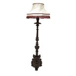 Antique mahogany standard lamp, turned column profusely carved with leaves, flutes and lobes, over a