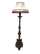 Antique mahogany standard lamp, turned column profusely carved with leaves, flutes and lobes, over a