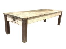 Large 19th century pine work bench, the rectangular top over drawer to each end, raised on square su