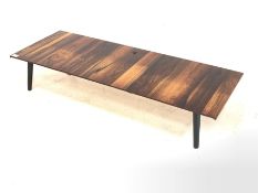 Hardwood low coffee table, raised on ebonised tapered splayed supports