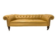 Victorian low back Chesterfield sofa, upholstered in button leather, raised on turned walnut support