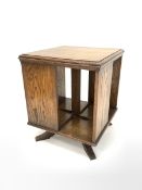 Early 20th century oak revolving bookcase, moulded top over four book recesses, raised on swivel cru
