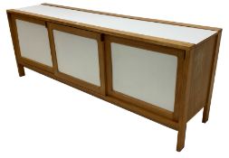Mid to late 20th century beech and white laminate sideboard, three sliding doors enclosing shelves a
