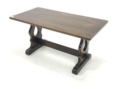 Rectangular oak coffee table, with pierced and shaped panel end supports with sledge feet, united by