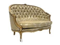 Louis XV style cream and gilt painted two seat sofa with squab cushion, upholstered in buttoned crea