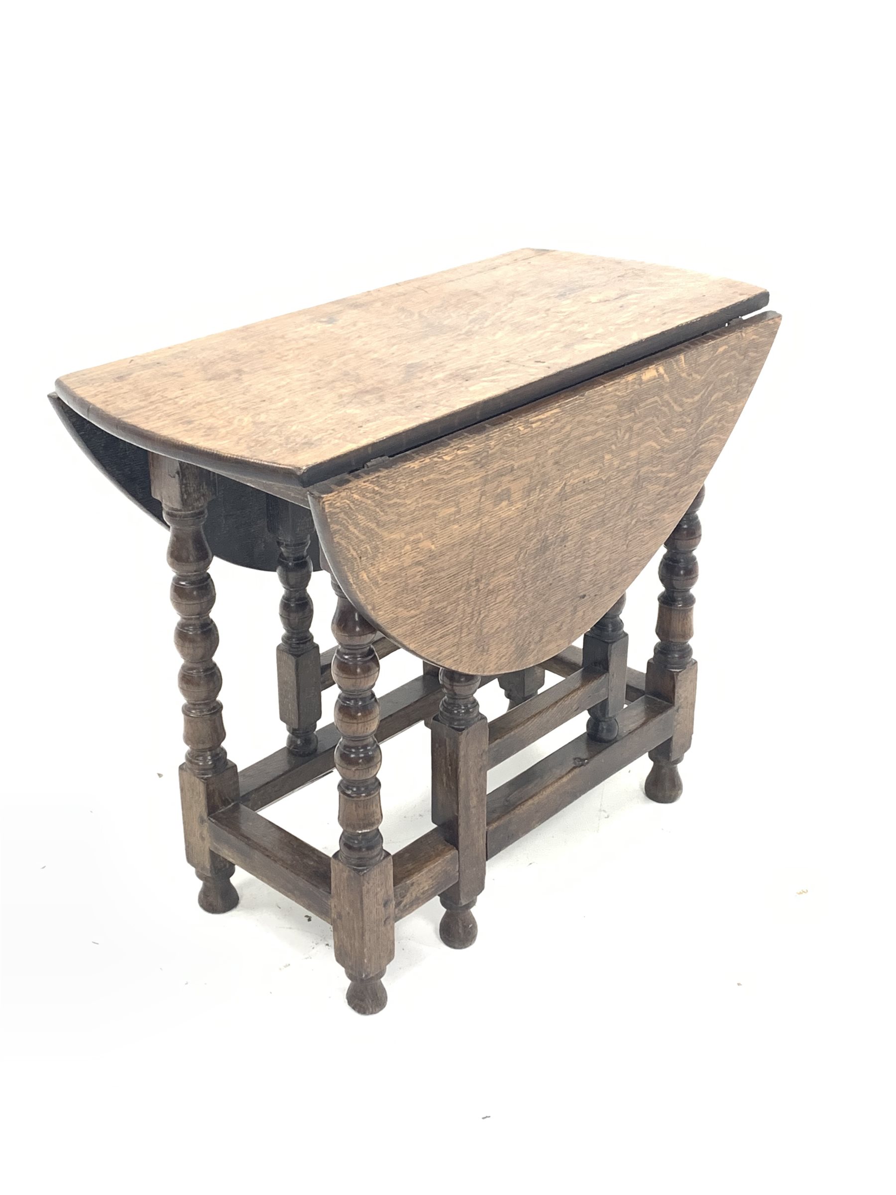 18th century oak gateleg table, the oval top with two drop leaves, over bobbin and block turned supp