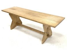 Yorkshire oak coffee table, the rectangular top raised on shaped panel end supports carved with York