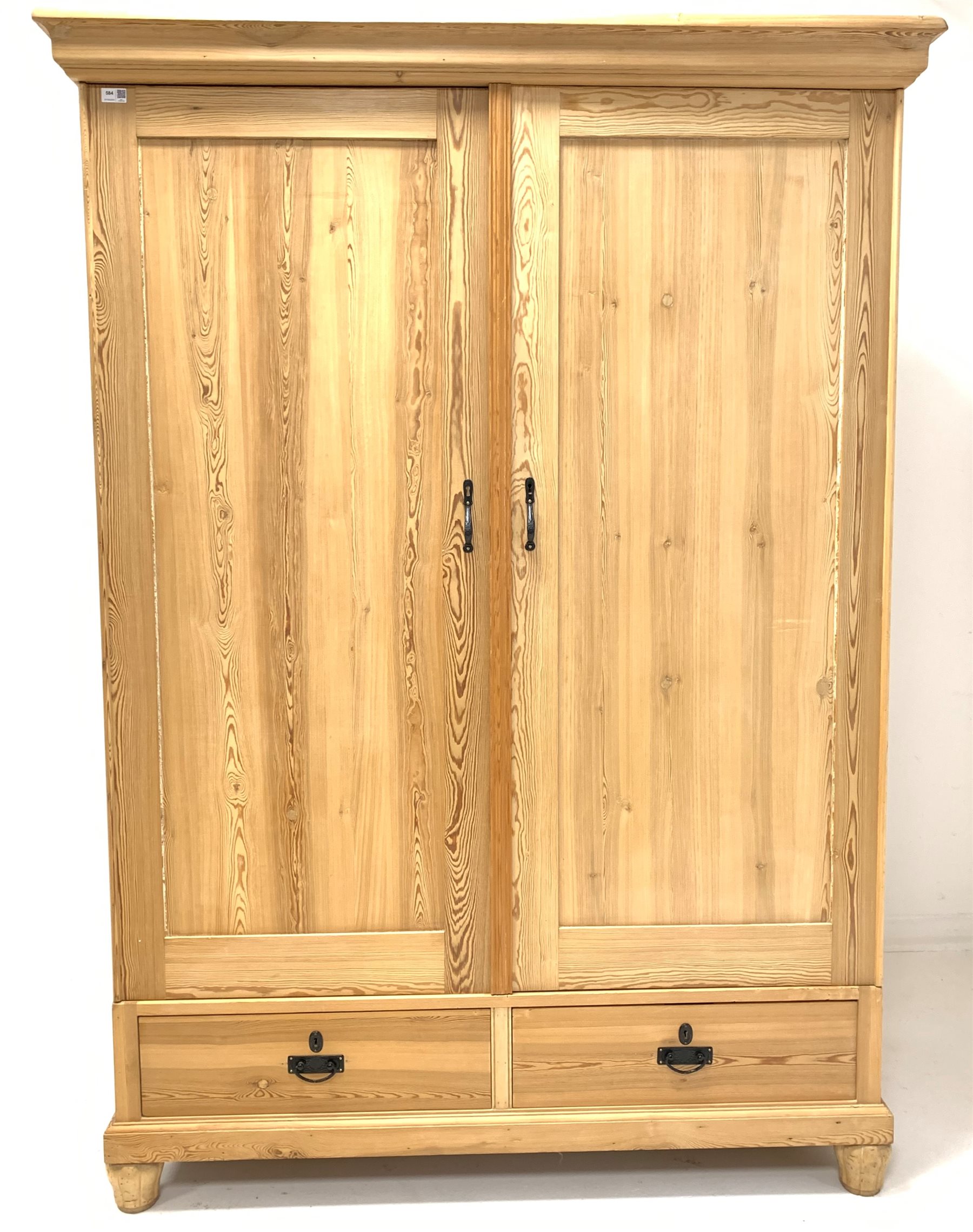 20th century stripped pine double wardrobe, projecting cornice over two panelled doors enclosing int