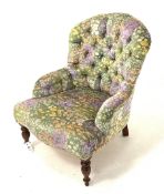 Victorian style upholstered bedroom chair, covered in deep buttoned floral fabric, raised on turned