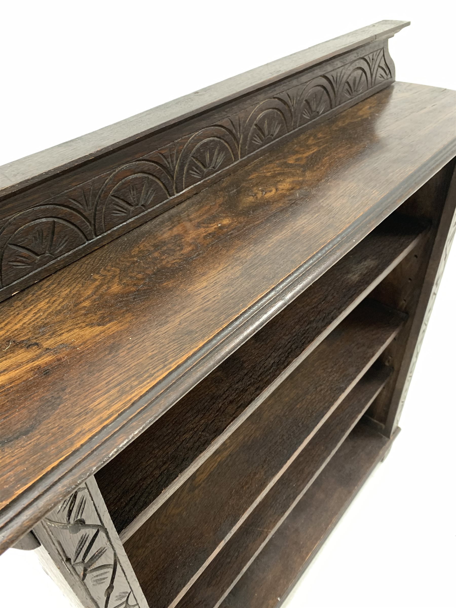 Early 20th century dark oak open bookcase, the raised back with lunette carving over three adjustabl - Image 6 of 6