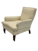 Late Victorian Howard style armchair, upholstered in natural linen, raised on turned front supports