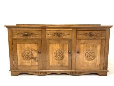 Yorkshire oak sideboard, three drawers over three fielded panelled cupboards each carved with Yorksh