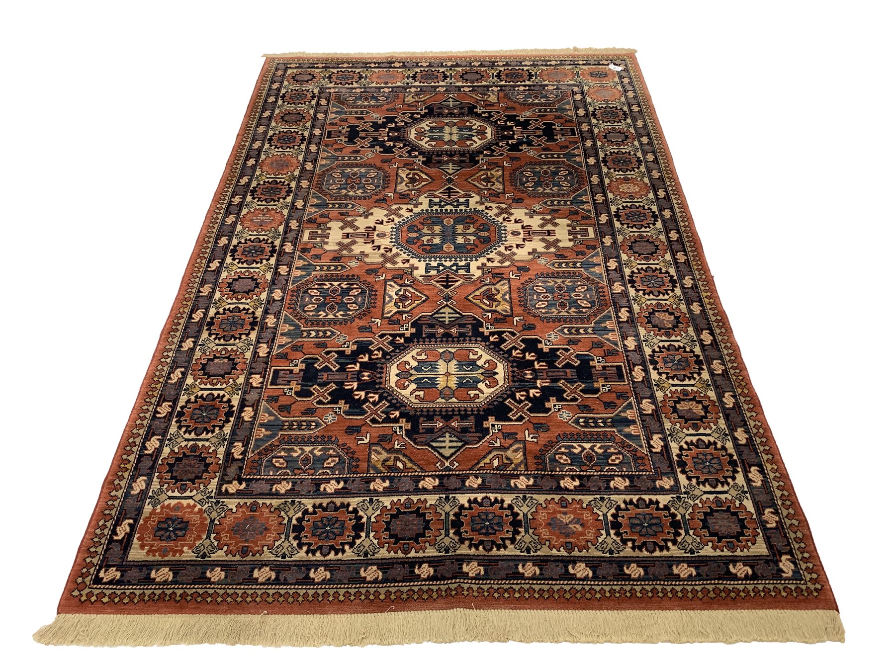 Persian Kadjar design ground rug, repeating lozenge and gul motif on red field, stylised floral deco