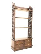 20th century floor standing mahogany three height open bookcase, with pierced panel end supports and