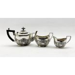 Edwardian bachelors silver three piece tea set of oval design with embossed decoration