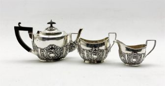 Edwardian bachelors silver three piece tea set of oval design with embossed decoration