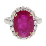 White gold oval ruby and round brilliant cut diamond cluster ring