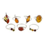 Seven silver amber stone set rings