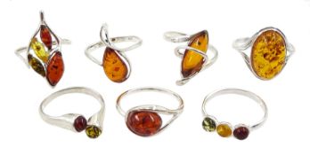 Seven silver amber stone set rings